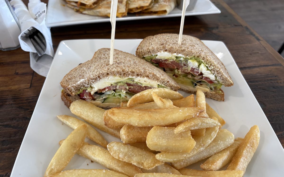 A BLT on grilled sourdough cut in half, served with steak fries